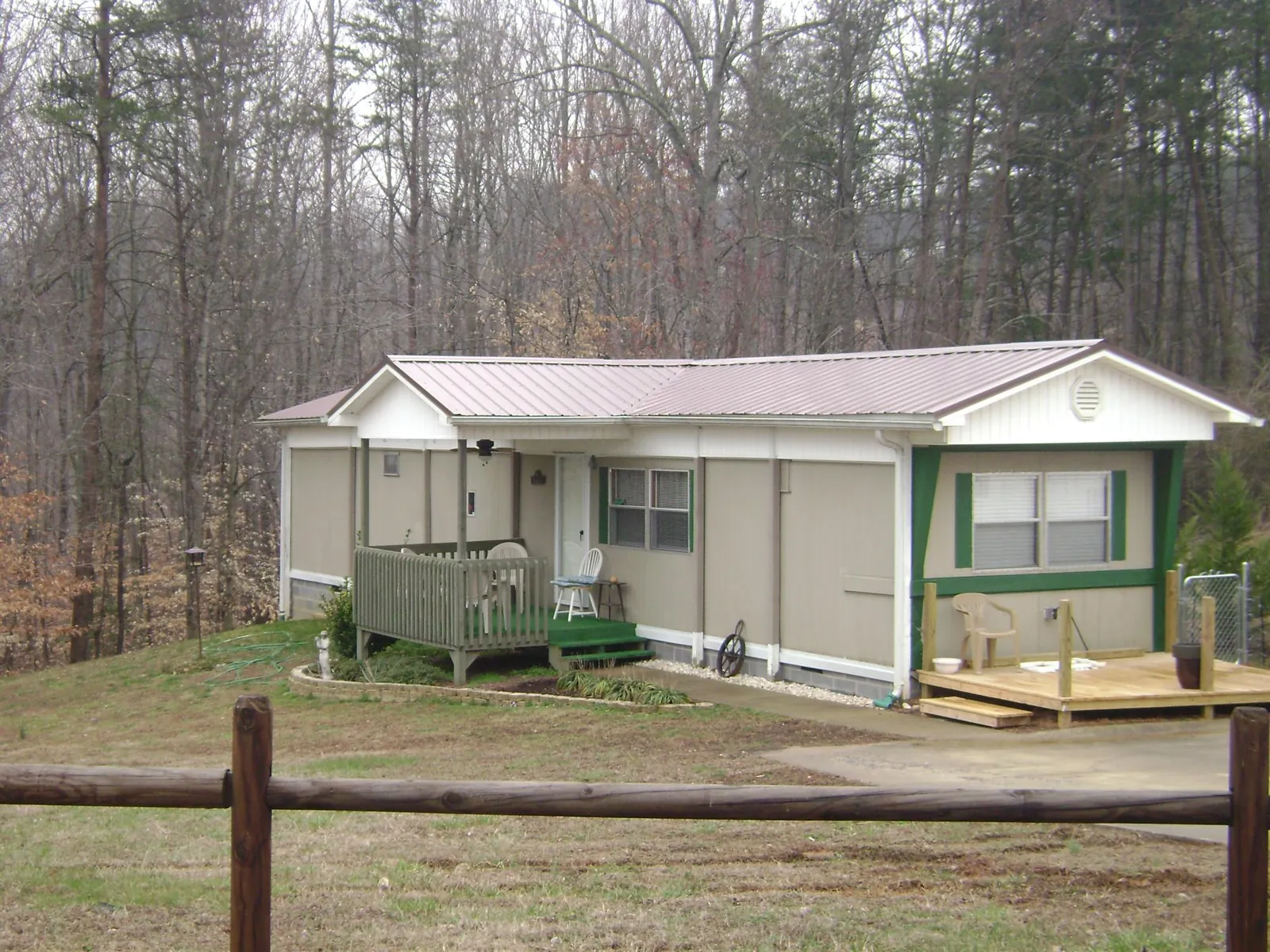 Mauve metal roof on a manufactured home with a new front deck in Sylvania